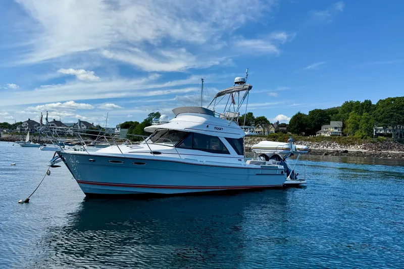 Frisky Yacht Photos Pics 2022 Cutwater C-32 CB boat anchored in scenic coastal waters.