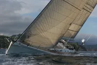 Sailing yacht Felci 71 from 2006 navigating through waves under cloudy skies.