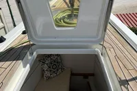 Open hatch on 2006 Custom Felci 71 yacht, revealing interior with cushion and pillow.