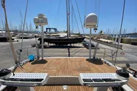 Custom Felci 71 yacht deck, 2006 model, in a marina with clear blue sky.