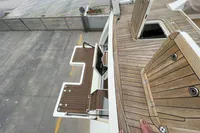 Deck view of a 2006 Custom Felci 71 yacht with wooden flooring and steps.