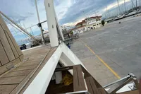 Custom Felci 71 yacht docked at marina, showcasing deck and nearby harbor.