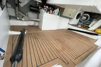 Engine room of 2006 Custom Felci 71 yacht with wooden flooring and storage compartments.