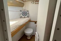 Compact cabin interior of 2006 Custom Felci 71 yacht with bed and toilet.