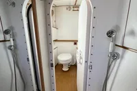 Custom Felci 71 yacht bathroom, 2006 model, featuring dual showers and a wooden floor.