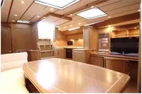 Luxurious interior of 2006 Custom Felci 71 yacht with modern kitchen and dining area.