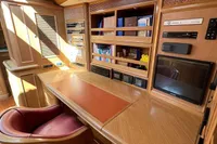 Luxurious wooden interior of 2006 Custom Felci 71 yacht with desk and chair.