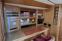 Luxurious wooden interior of 2006 Custom Felci 71 yacht with desk and shelving.