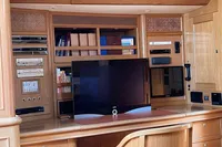 Luxurious yacht interior with entertainment system, wooden cabinetry, and modern TV on a Felci 71, 2006.