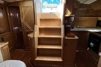 Luxurious interior of 2006 Custom Felci 71 yacht with wooden finishes and staircase.