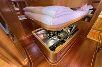 Luxurious 2006 Custom Felci 71 yacht interior with engine access under bed.