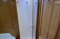 Wood-paneled yacht bathroom with shower, Custom Felci 71, 2006 model.