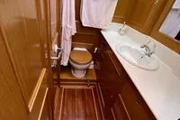 Luxurious wooden bathroom interior on a 2006 Custom Felci 71 yacht.
