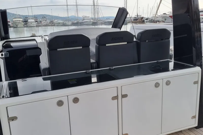  Yacht Photos Pics 2019 Fjord 44 Open yacht interior with sleek seating and modern design in a marina setting.