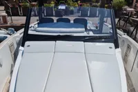 2019 Fjord 44 Open boat with sleek white seating and windshield, docked in a marina.