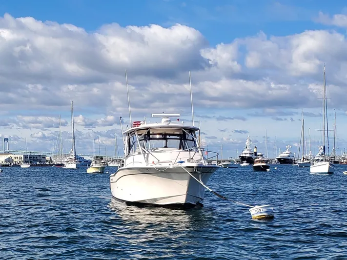 Season Pass Yacht Photos Pics 2007 Grady-White Express 330 boat anchored in a marina under a cloudy sky.