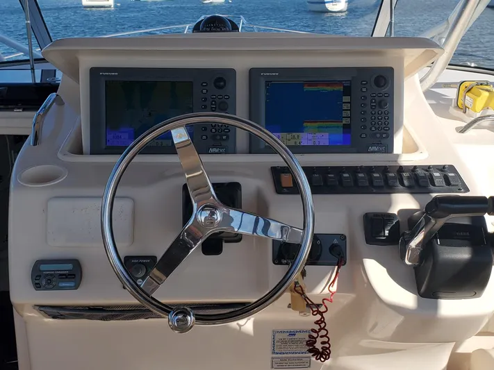 Season Pass Yacht Photos Pics 2007 Grady-White Express 330 helm with dual navigation screens and steering wheel.