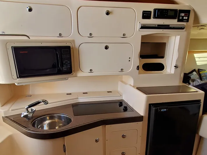 Season Pass Yacht Photos Pics 2007 Grady-White Express 330 boat kitchen with microwave, sink, and fridge.