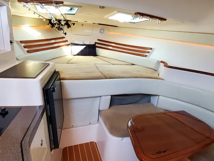 Season Pass Yacht Photos Pics 2007 Grady-White Express 330 cabin interior with bed, seating, and kitchenette.