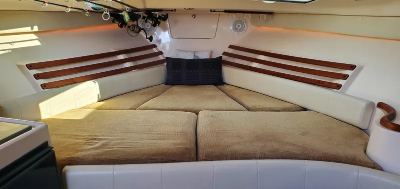 Season Pass Yacht Photos Pics 2007 Grady-White Express 330 cabin interior with cushioned seating and wood accents.