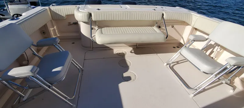 Season Pass Yacht Photos Pics 2007 Grady-White Express 330 boat interior with seating, on calm water.