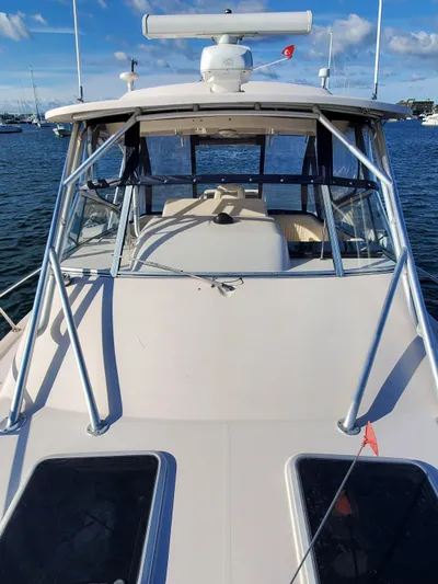 Season Pass Yacht Photos Pics 2007 Grady-White Express 330 boat on water, clear sky, front view.
