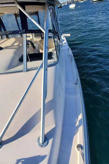 Season Pass Yacht Photos Pics 2007 Grady-White Express 330 boat on water, side view with railing.