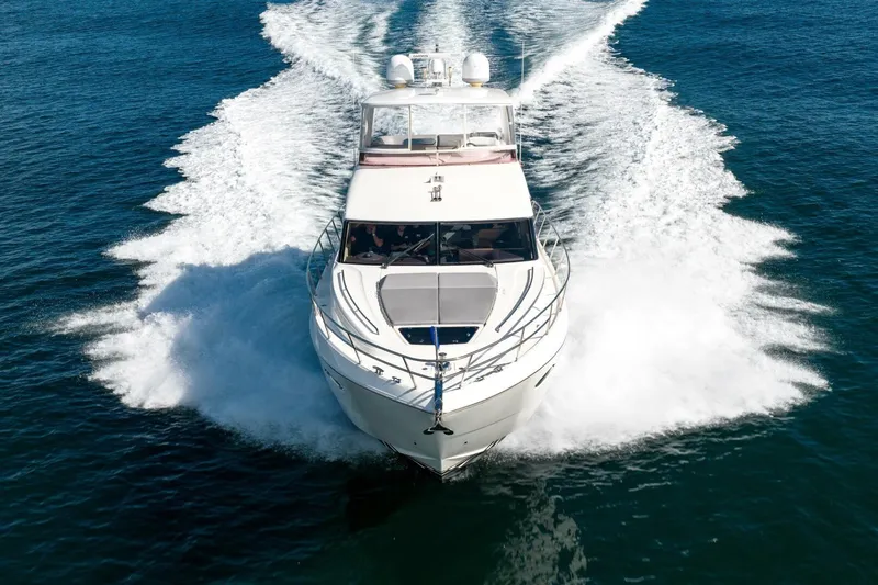 Sea Bandit Yacht Photos Pics 2015 Princess 56 Flybridge Motor Yacht cruising on open water.
