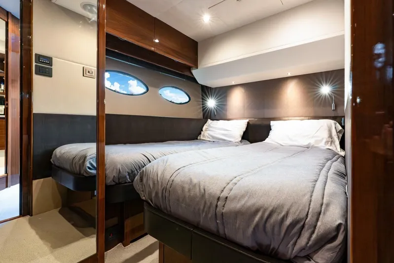 Sea Bandit Yacht Photos Pics Luxurious twin bedroom in 2015 Princess 56 Flybridge Motor Yacht, featuring modern design and comfort.