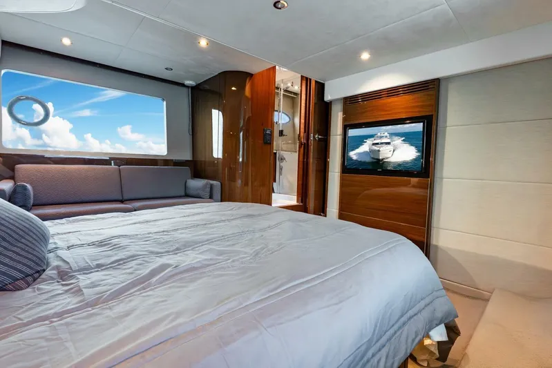 Sea Bandit Yacht Photos Pics Luxurious bedroom interior of 2015 Princess 56 Flybridge Motor Yacht with TV and ocean view.