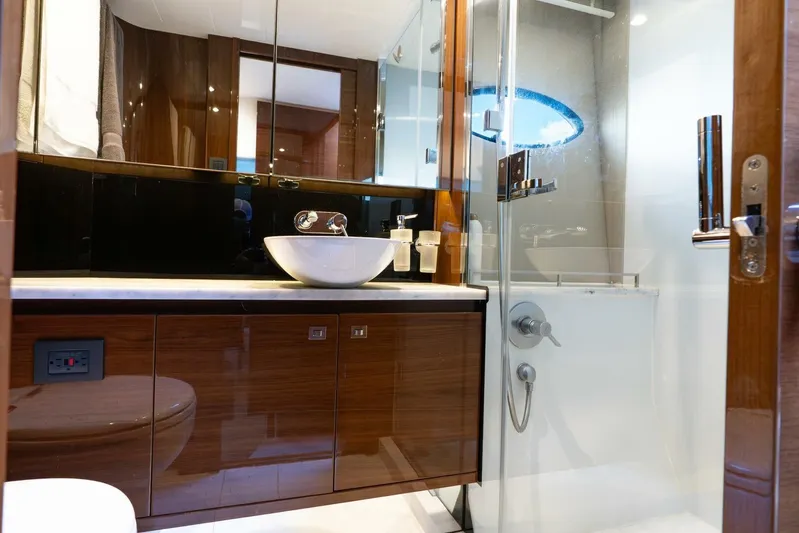 Sea Bandit Yacht Photos Pics Luxurious bathroom in 2015 Princess 56 Flybridge Motor Yacht with modern fixtures and elegant design.