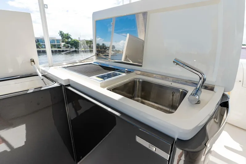 Sea Bandit Yacht Photos Pics Outdoor kitchen on 2015 Princess 56 Flybridge Motor Yacht with sink and grill.
