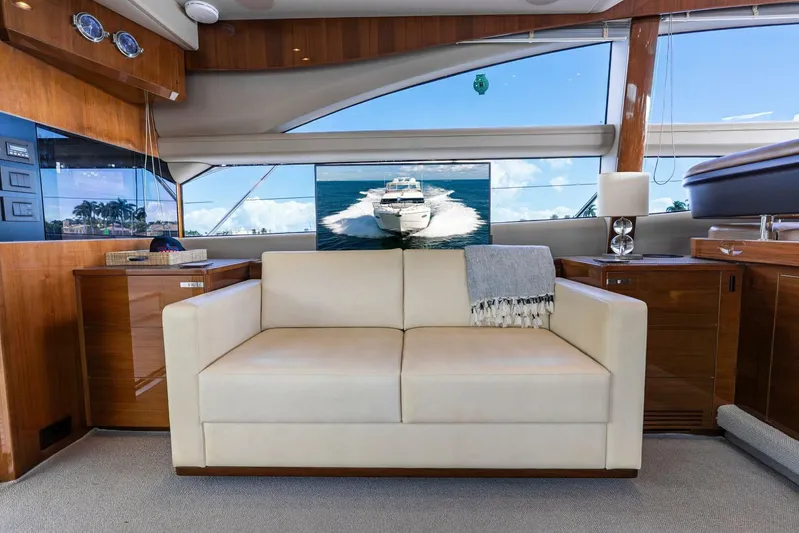 Sea Bandit Yacht Photos Pics Luxurious interior of 2015 Princess 56 Flybridge Motor Yacht with elegant seating and ocean view.