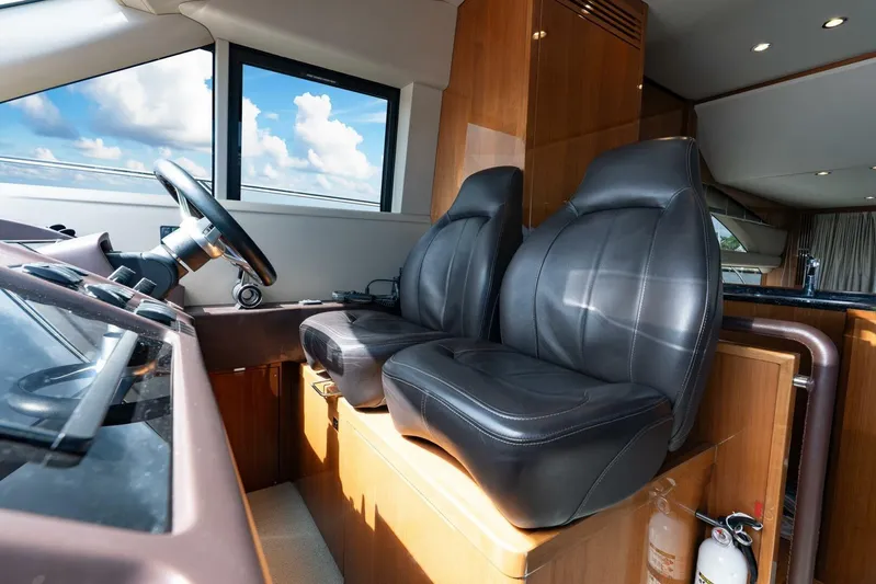 Sea Bandit Yacht Photos Pics Interior of 2015 Princess 56 Flybridge Yacht with leather seats and steering wheel.