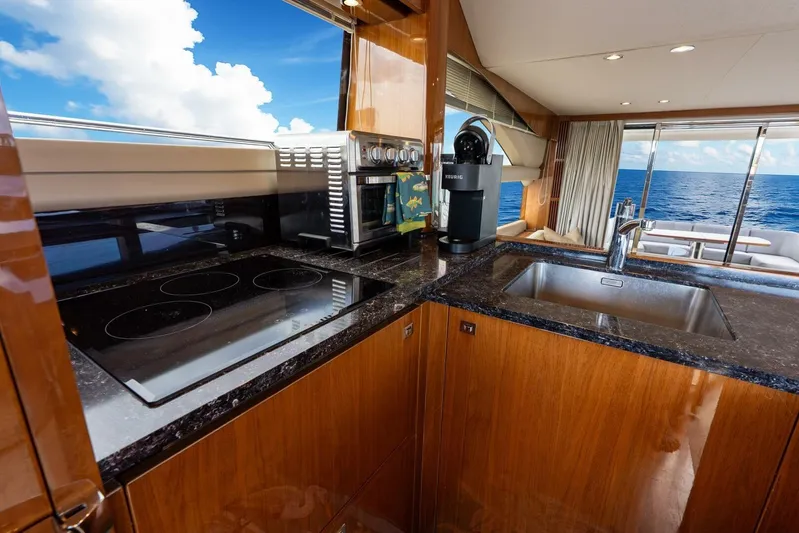 Sea Bandit Yacht Photos Pics Luxurious kitchen interior of 2015 Princess 56 Flybridge Motor Yacht with ocean view.