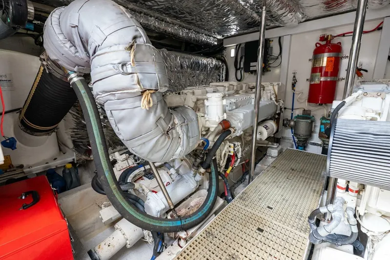 Sea Bandit Yacht Photos Pics Engine room of 2015 Princess 56 Flybridge Motor Yacht, featuring insulated components and fire extinguisher.