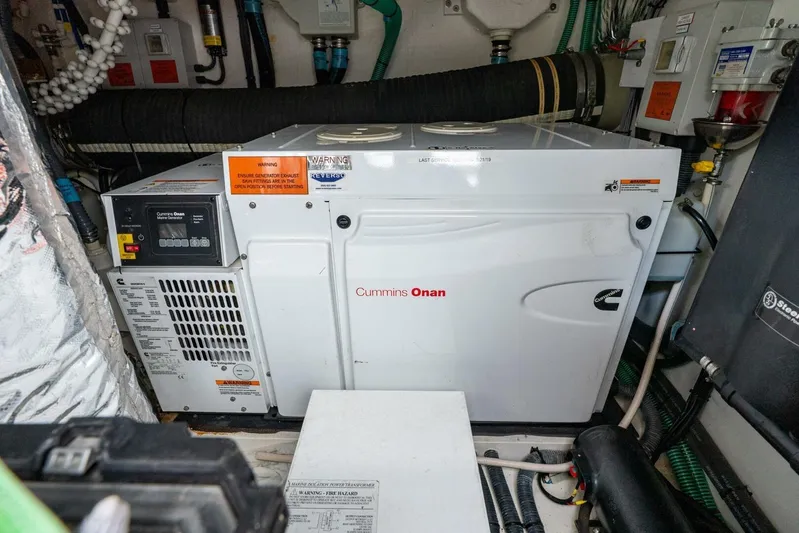 Sea Bandit Yacht Photos Pics Cummins Onan generator in 2015 Princess 56 Flybridge Motor Yacht engine room.