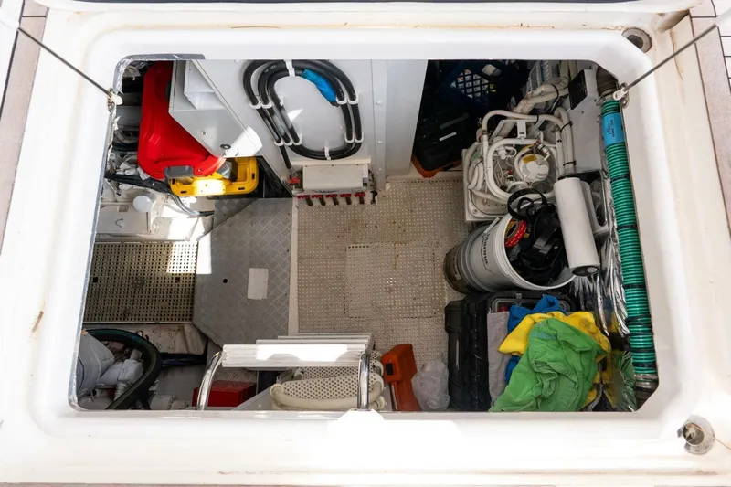 Sea Bandit Yacht Photos Pics Engine room of 2015 Princess 56 Flybridge Motor Yacht, showing equipment and storage.