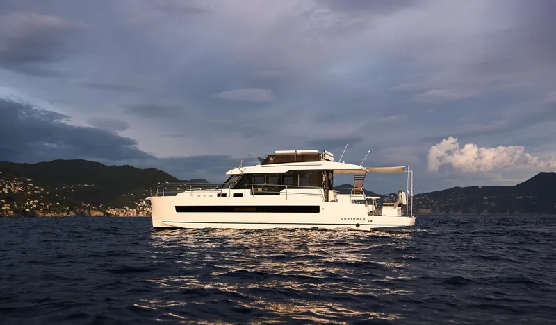  Yacht Photos Pics 2025 Northman 1300 yacht cruising on open water at sunset.