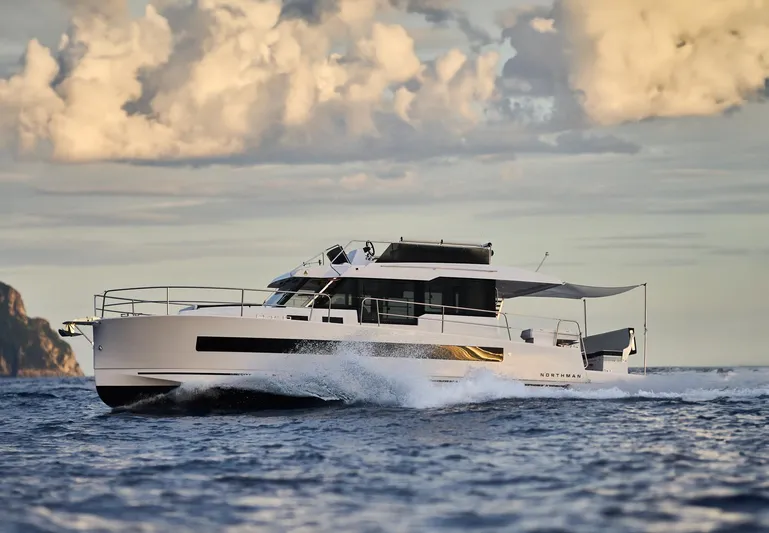  Yacht Photos Pics 2025 Northman 1300 yacht cruising on open water under a cloudy sky.