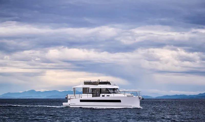  Yacht Photos Pics Modern Northman 1300 yacht cruising on open sea under cloudy sky, 2025 model.