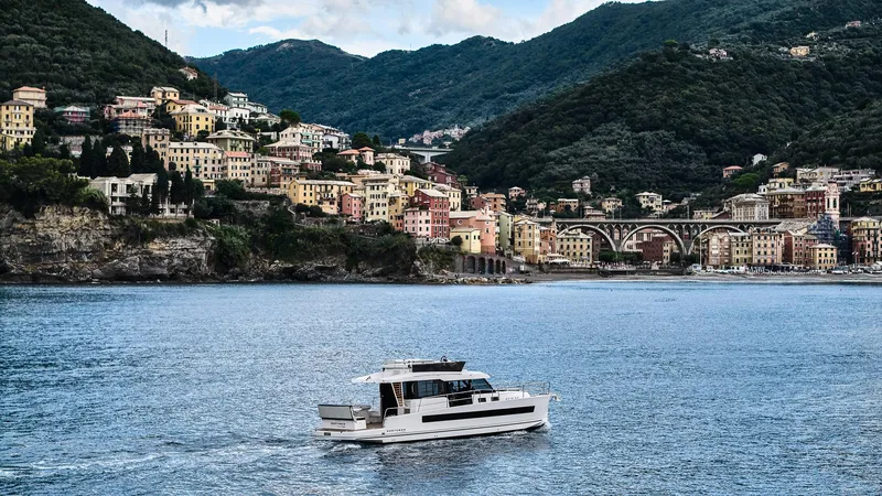  Yacht Photos Pics Modern Northman 1300 yacht cruising near colorful coastal town, 2025 model.