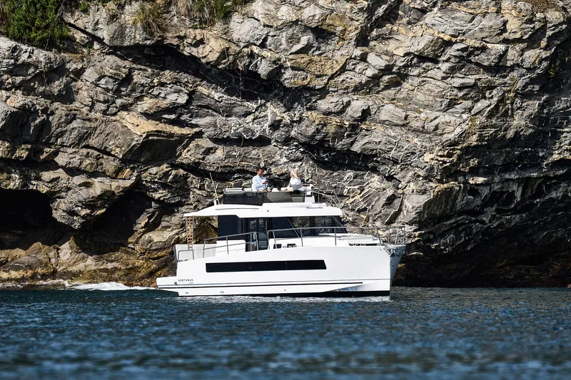  Yacht Photos Pics 2025 Northman 1300 yacht cruising near rocky cliffs.