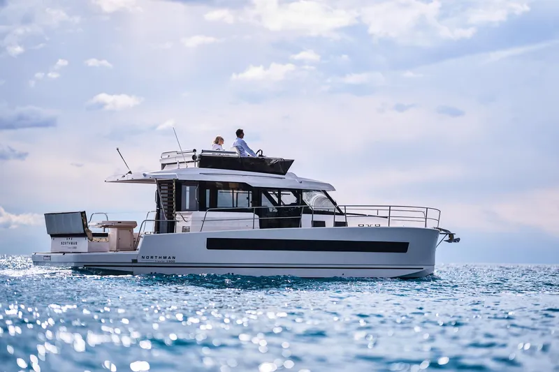  Yacht Photos Pics 2025 Northman 1300 yacht cruising on open water under a partly cloudy sky.
