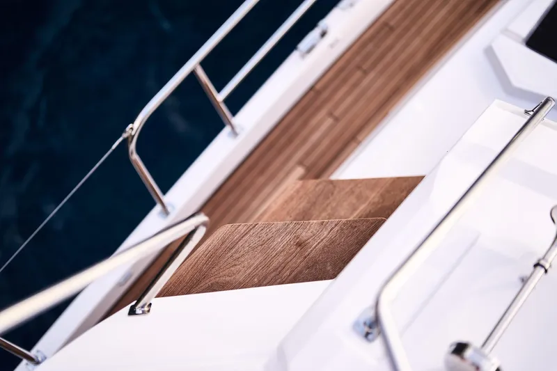  Yacht Photos Pics Deck view of 2025 Northman 1300 yacht with wooden flooring and metal railings.