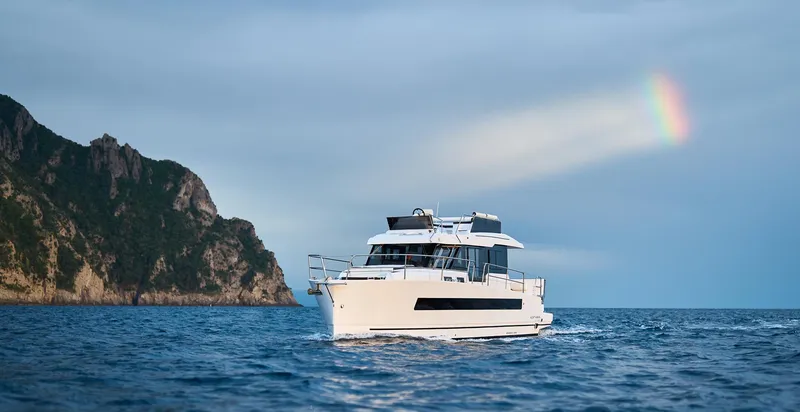  Yacht Photos Pics Luxury Northman 1300 yacht cruising near cliffs under a rainbow, 2025 model.