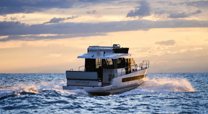  Yacht Photos Pics 2025 Northman 1300 yacht cruising at sunset on open sea.