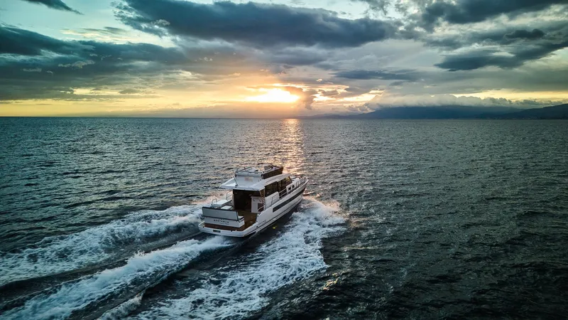  Yacht Photos Pics Northman 1300 yacht cruising at sunset, 2025 model, on open sea.