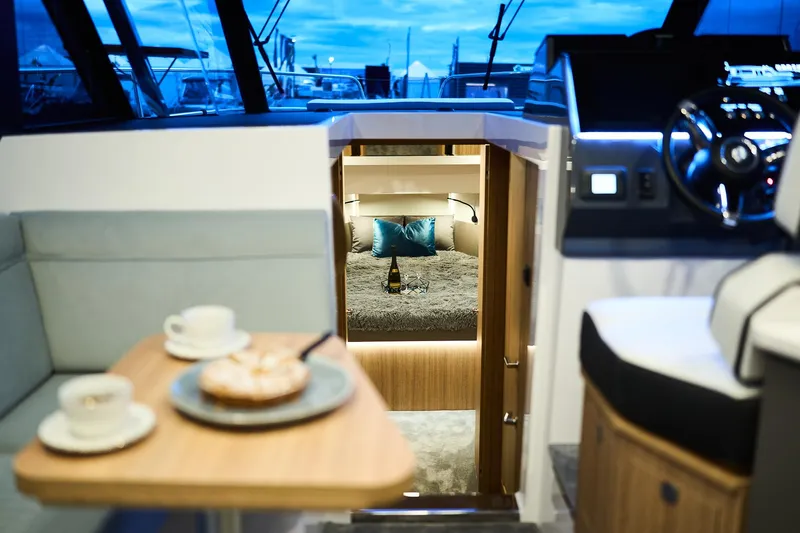  Yacht Photos Pics Luxurious interior of 2025 Northman 1300 yacht with cozy cabin and dining area.
