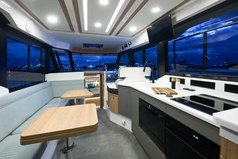 Yacht Photos Pics Luxurious interior of 2025 Northman 1300 yacht with modern kitchen and seating area.